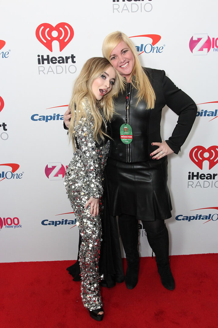 A fan poses with Sabrina Carpenter at the iHeartRadio Meet & Greet