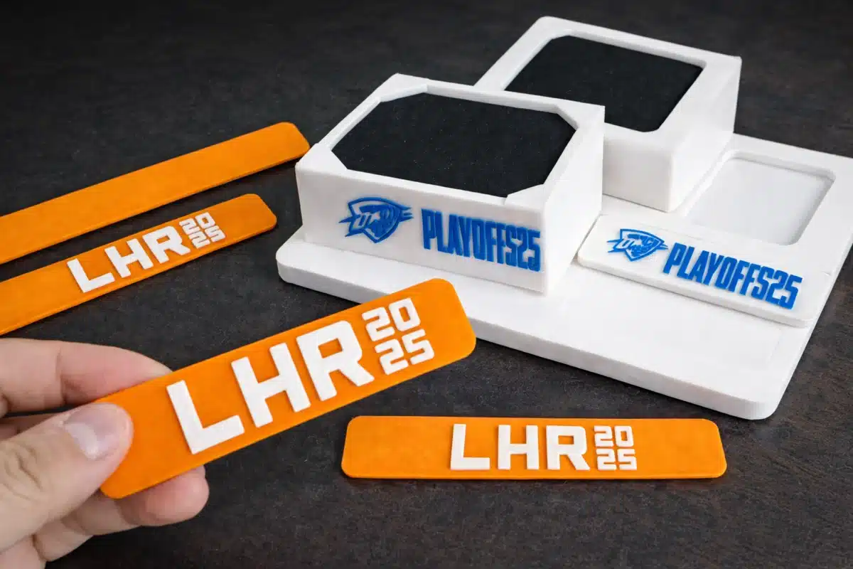 Orange LHR 2025 branded wristbands displayed alongside custom Robo Sketcher hardware with Playoffs 25 branding.
